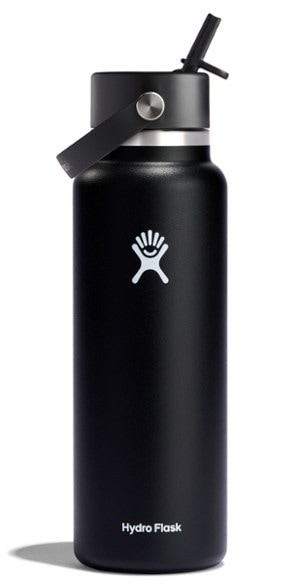 Hydro Flask 40 oz insulated water bottle with straw cap on a hiking trail