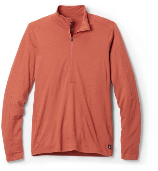 Front view of the Merino wool half-zip top on a male model in a hiking setting.