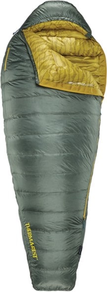 Therm-a-Rest Questar 20 Sleeping Bag with a hiker inside at a campsite, demonstrating warmth and comfort.