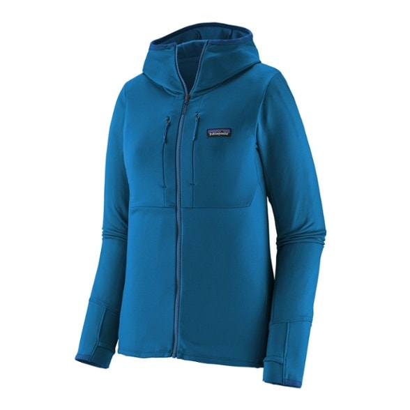 Patagonia Women's R1 Thermal Hoody on a snowy trail, highlighting its sleek design and warm fabric.