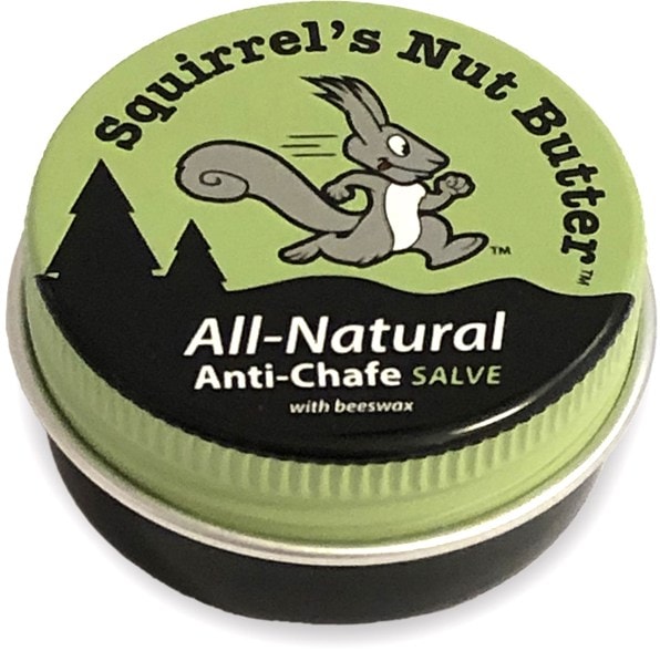 Squirrel's Nut Butter Skin Protection Salve in a 0.5 oz tin on a running trail.