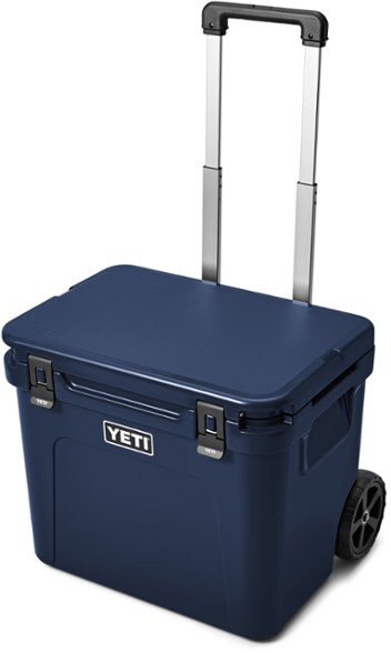 YETI Trailblazer 60 wheeled cooler on a sandy beach, highlighting its rugged wheels and spacious interior.