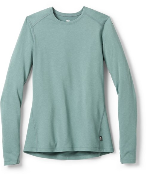 Eco-friendly women's midweight base layer top in action during a winter hike.