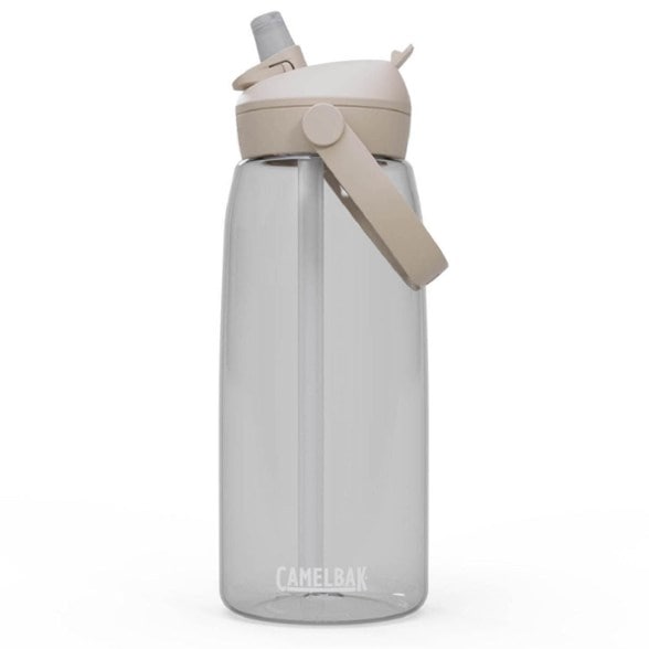 CamelBak Thrive Flip Straw water bottle with a comfortable carry handle in a hiking setting.