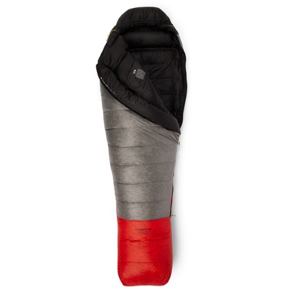 Mountain Hardwear Phantom sleeping bag in action on an alpine hike, showcasing its lightweight and packable design.
