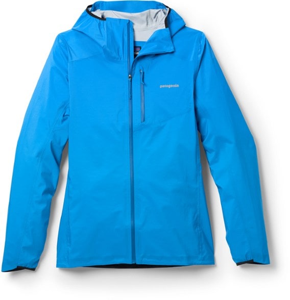Patagonia Women's Ultralight Storm Racer Jacket folded neatly in a backpack, demonstrating its packable feature.
