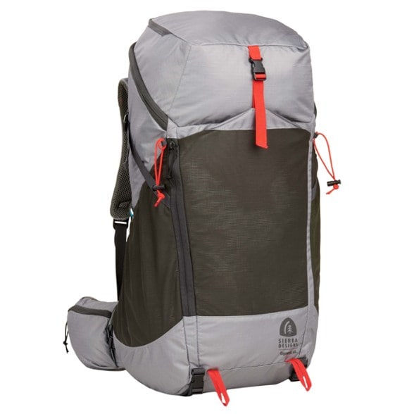 AdventurePro 60L Multiday Backpack in rugged terrain, showcasing its durable design and external pockets.