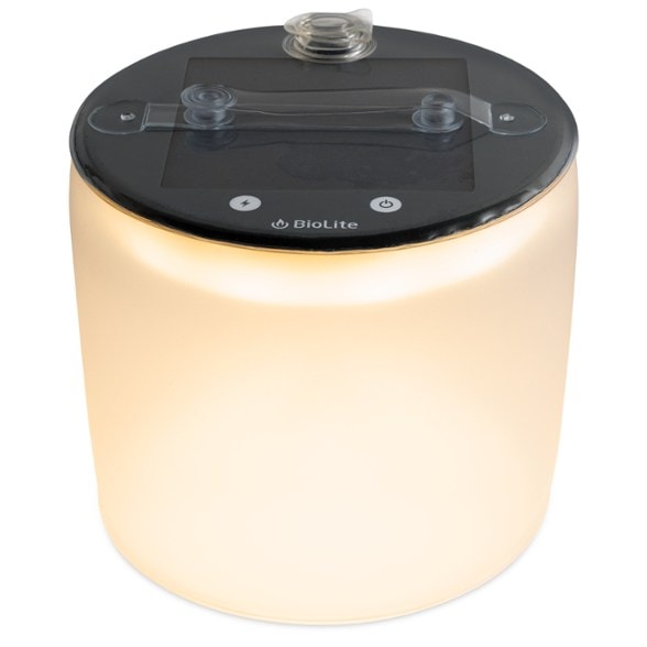 Luci 360 solar lantern on a camping table, providing warm lighting.