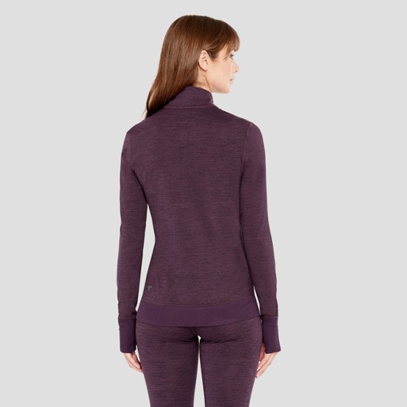 Front view of Cloud Nine Women's Half-Zip Base Layer Top in action during a winter run.