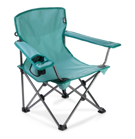 Lightweight kids camping chair with armrests set up by the campfire.