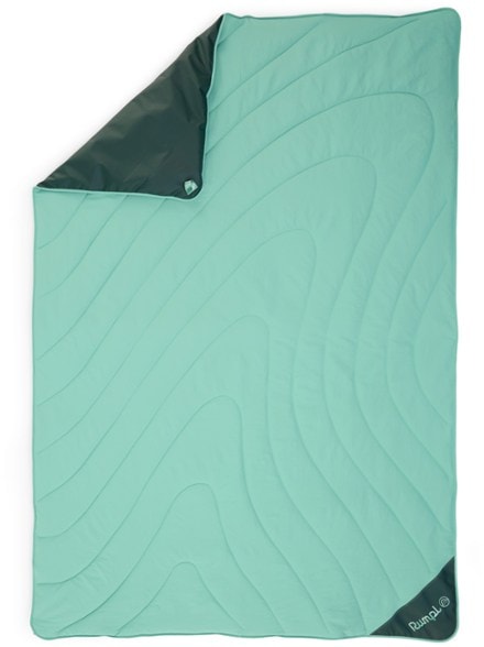 Trailblazer Overland waterproof camping mat laid out on rocky beach showing padded insulation and durable ground cover