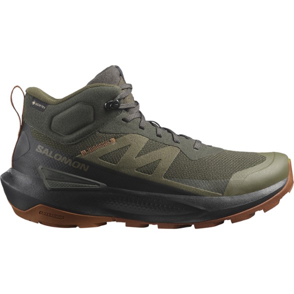 Side view of men's GORE-TEX Elixir Activ Mid hiking boots on rocky terrain.