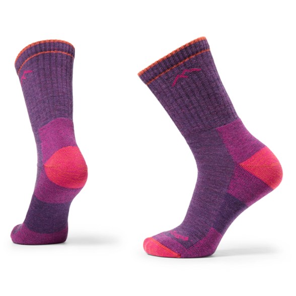 Darn Tough Women's Micro Crew Cushioned Hiking Socks displayed on a rock during a hike.