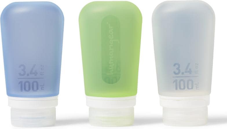 Close-up of GoToob+ silicone travel bottles filled with shampoo and lotion.