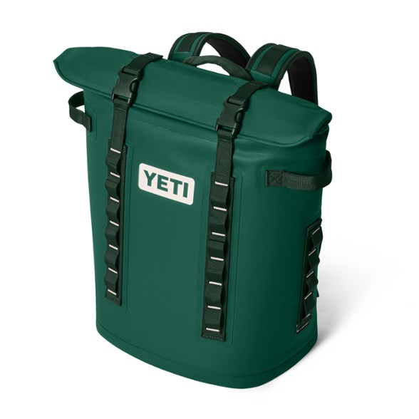 YETI Hopper M20 2.0 Backpack Cooler with magnetic closure opened in a camping site.