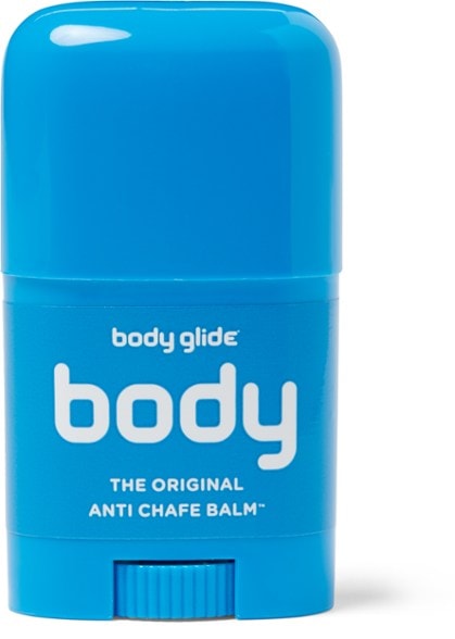 Close-up of GlideGuard anti-chafe balm against workout gear — shows compact size and eco-friendly packaging.