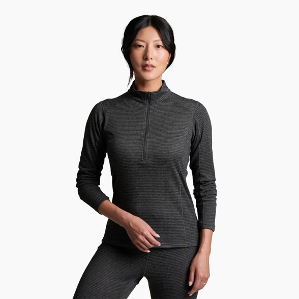 Front view of the KÜHL Women's Reactiv Lite Grid Quarter-Zip Top in action during a winter hike.