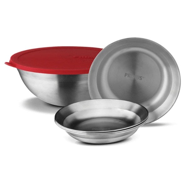 Ultimate Campfire Serving Set displaying four stainless steel plates and a large bowl against a scenic camping backdrop.