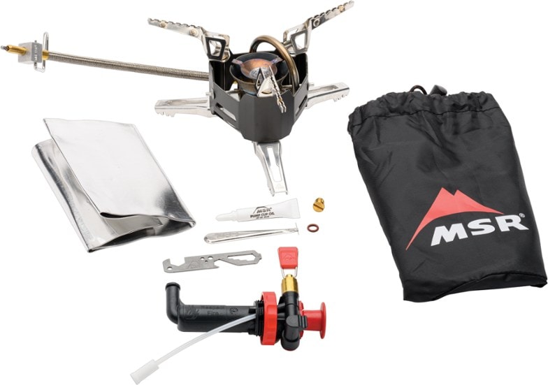 MSR XGK EX stove setup in a campsite with cookware.