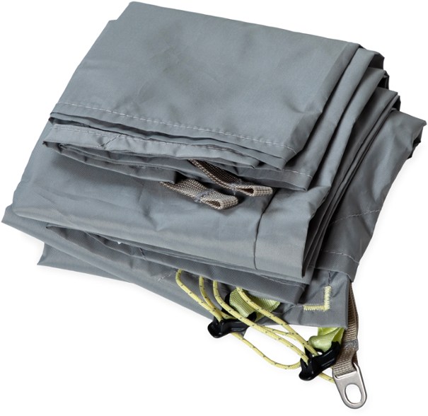 Top view of TrailGuard 3P tent footprint laid out on rocky terrain with backpack nearby