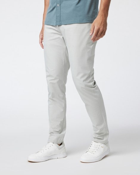 Side view of men's slim athletic pants showcasing mobility during a workout.