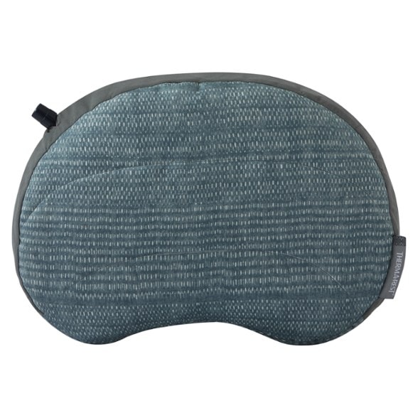 Eco-friendly high loft inflatable camping pillow used in a tent at night, showcasing its comfort.
