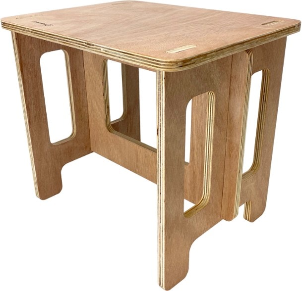 Metolius Adventure Folding Camp Table set up next to a tent, showcasing its stability and design.