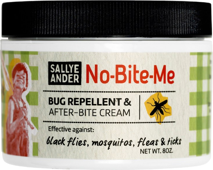 Close-up of Safe & Natural Bug Defender bottle showcasing herbal ingredients.