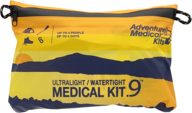 Adventure Ready Waterproof First Aid Kit in a scenic hiking setting, showcasing its compact design.