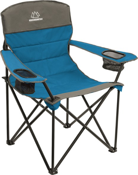 ComfortMax Quilted Portable Chair in a park with a person sitting comfortably, showcasing its support and style.