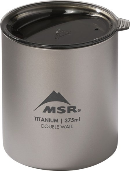 Titanium Voyager Double-Wall Mug with lid on a campsite table