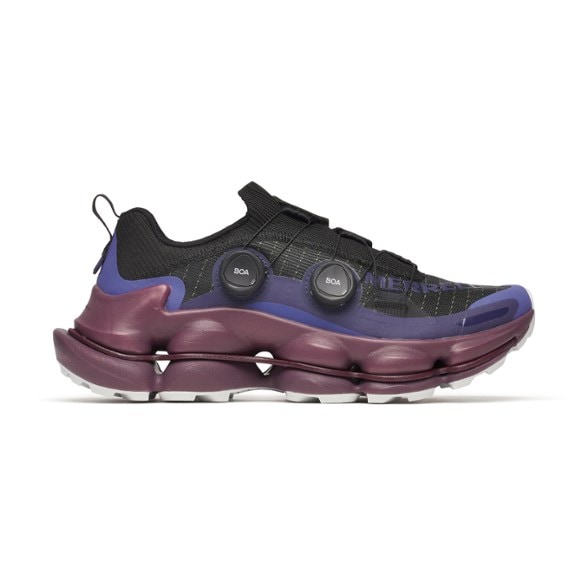 Side view of men's hiking shoes with durable grip and BOA lacing system on rocky trail