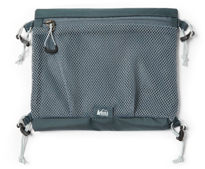Front view of the versatile mesh pocket attached to a hiking backpack, showcasing its ample storage and breathable design.