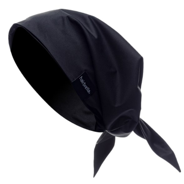 Front view of satin-lined waterproof bandana tied around curly hair during a trail run