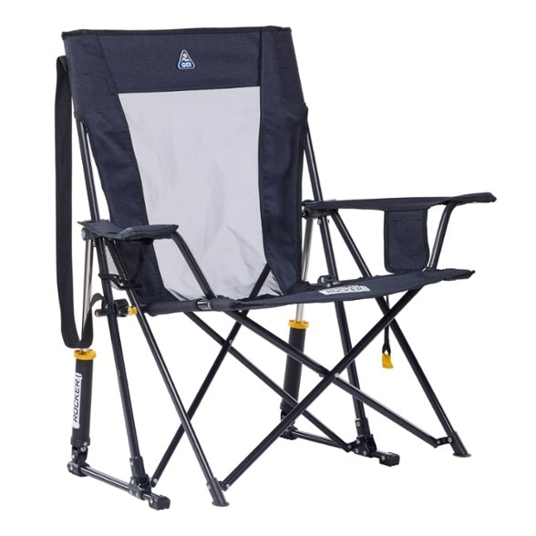 Front view of TrailEase XL rocking chair set up at a forest campsite