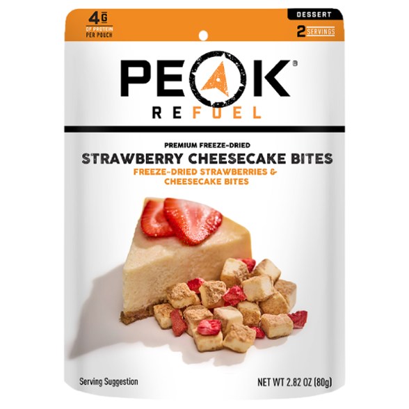 Peak Refuel Strawberry Cheesecake Bites displayed with hiking gear, ideal for outdoor enthusiasts.