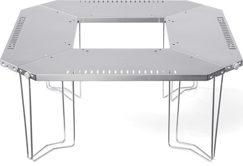 Jikaro camping table configured in octagonal shape around a glowing fire pit