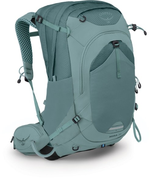 Osprey Mira Trailflow 32L hydration pack side view with hipbelt pockets and trekking pole attachments visible.