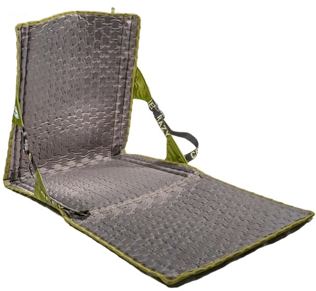 Hex 2.0 Power Lounger Chair set up in a lush camping area, showcasing its comfort and portability.