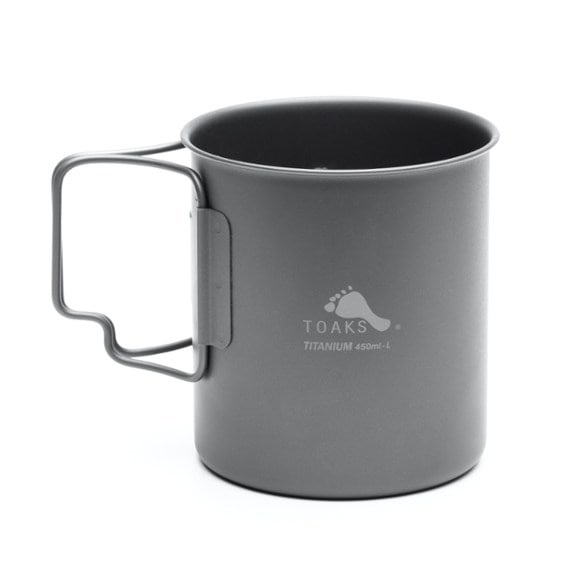 TOAKS ultralight titanium backpacking cup with scenic mountain backdrop