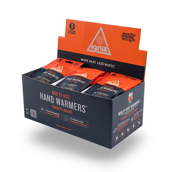 Front view of Ignik AirBarrier™ hand warmer with resealable pouch on snowy surface