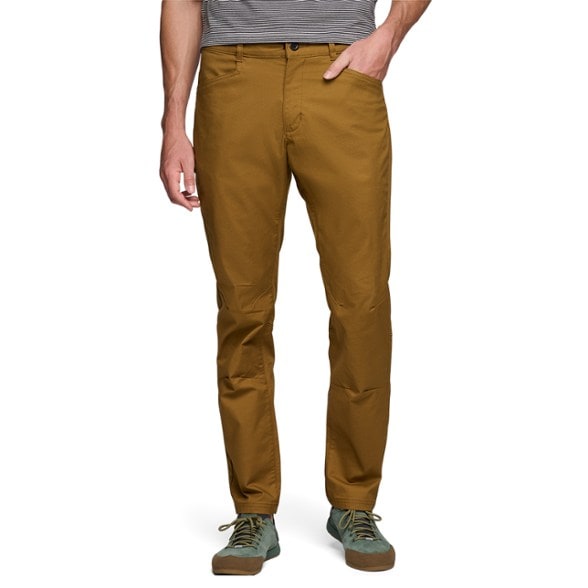 Front view of TrekMantle pants on hiker scaling a granite wall — men's hiking pants