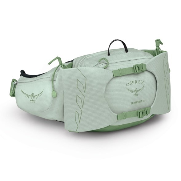 Osprey Tempest 6 waist pack displayed on a hiking trail, showcasing adjustable straps and hipbelt pockets.