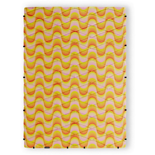 Nomadix SnappyCamp Convertible Blanket laid flat on a grassy campsite showing size and surface texture
