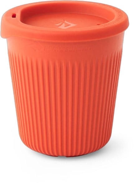 Summit Sipper Cup displayed outdoors with a scenic view, showcasing its compact design.