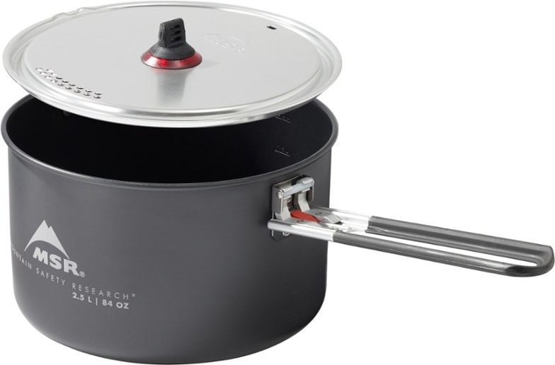 Angled view of the 2.5L ceramic pot with strainer lid attached, resting on a camping stove