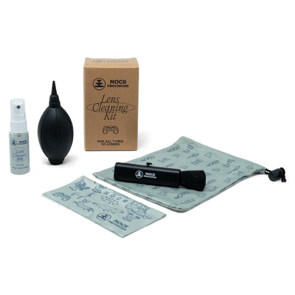 ProClear Lens Cleaning Kit with brush, bouffer, and lens cloth displayed on a wooden table.
