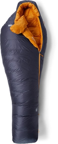 Magma 15 sleeping bag shown in a cozy camping setup, showcasing its warm color and lightweight design.
