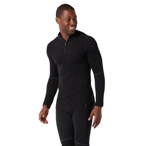 Men's Thermal Max Merino Quarter-Zip Base Layer Top in action during a winter hike.