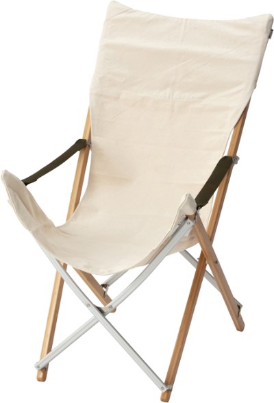 Snow Peak bamboo lounge chair in a campsite setting with a view of mountains.